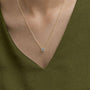 Gold chain lab grown diamond pendant necklace from Delux Jewelry, worn with green top