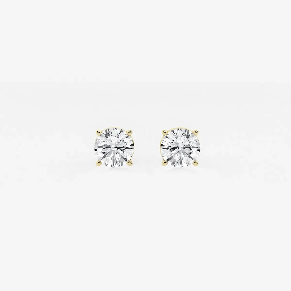 Round lab grown diamond stud earrings in yellow gold setting on white background