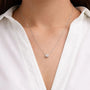 Woman wearing delicate oval lab grown diamond pendant necklace by Delux Jewelry