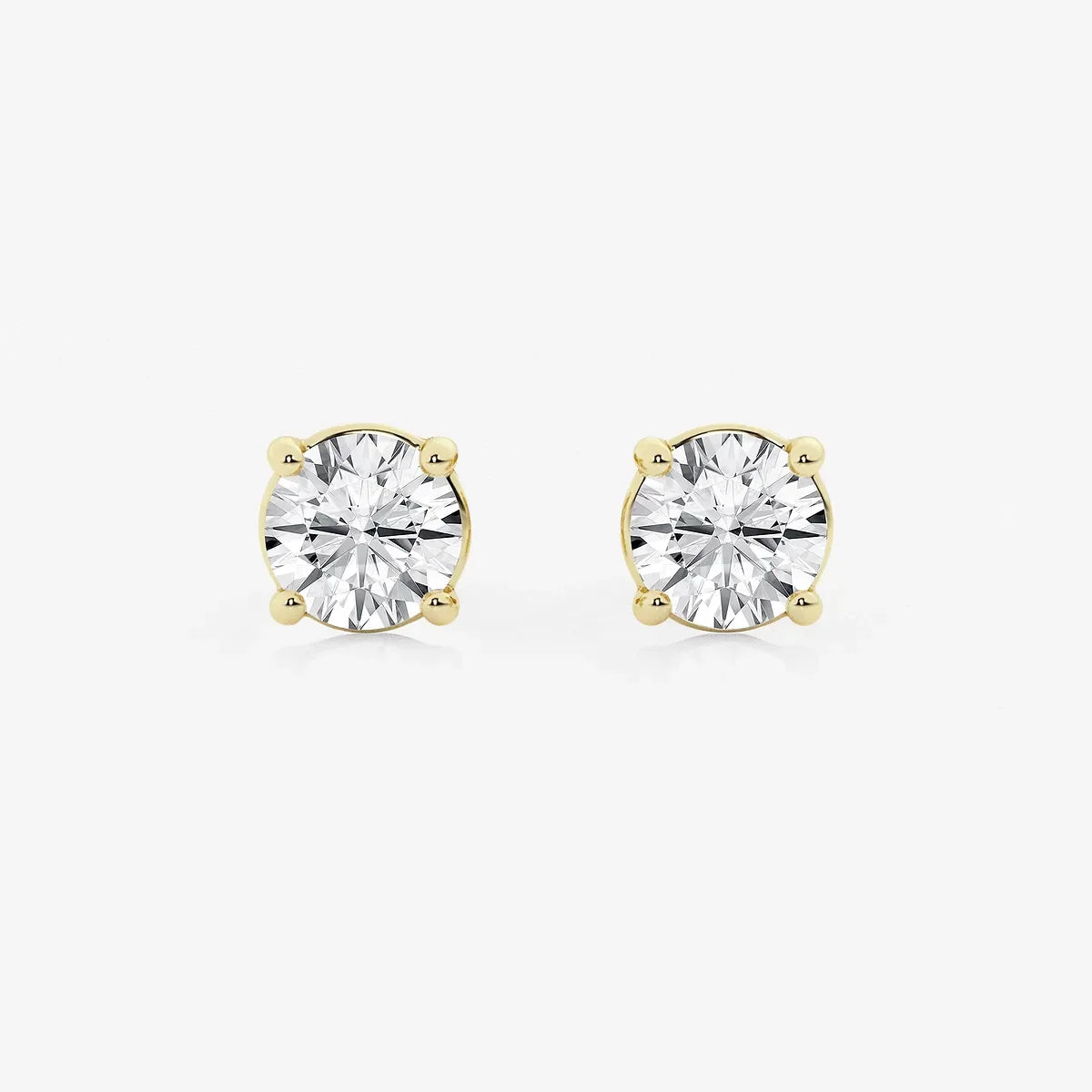 Round lab grown diamond stud earrings in yellow gold setting from Delux Jewelry