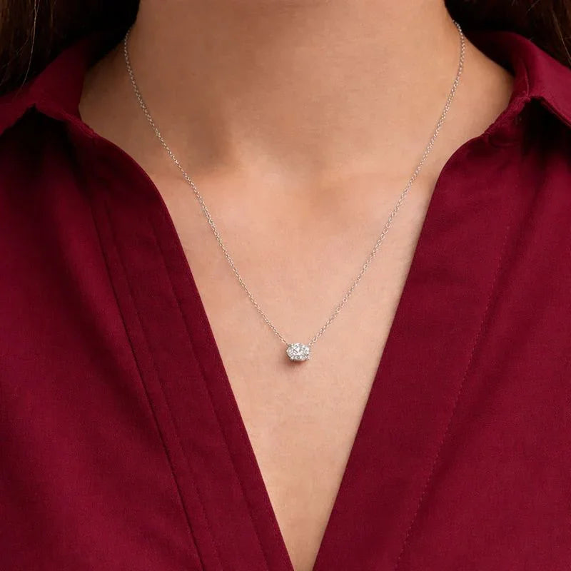 Lab grown diamond oval pendant necklace on model wearing deep red blouse, Delux Jewelry