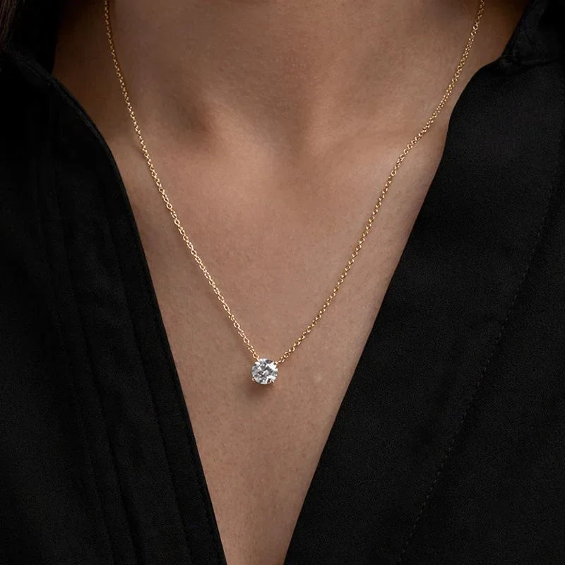 Gold necklace with round lab grown diamond pendant from Delux Jewelry on model's neck