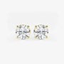 Round lab grown diamond stud earrings with yellow gold prong settings on white background