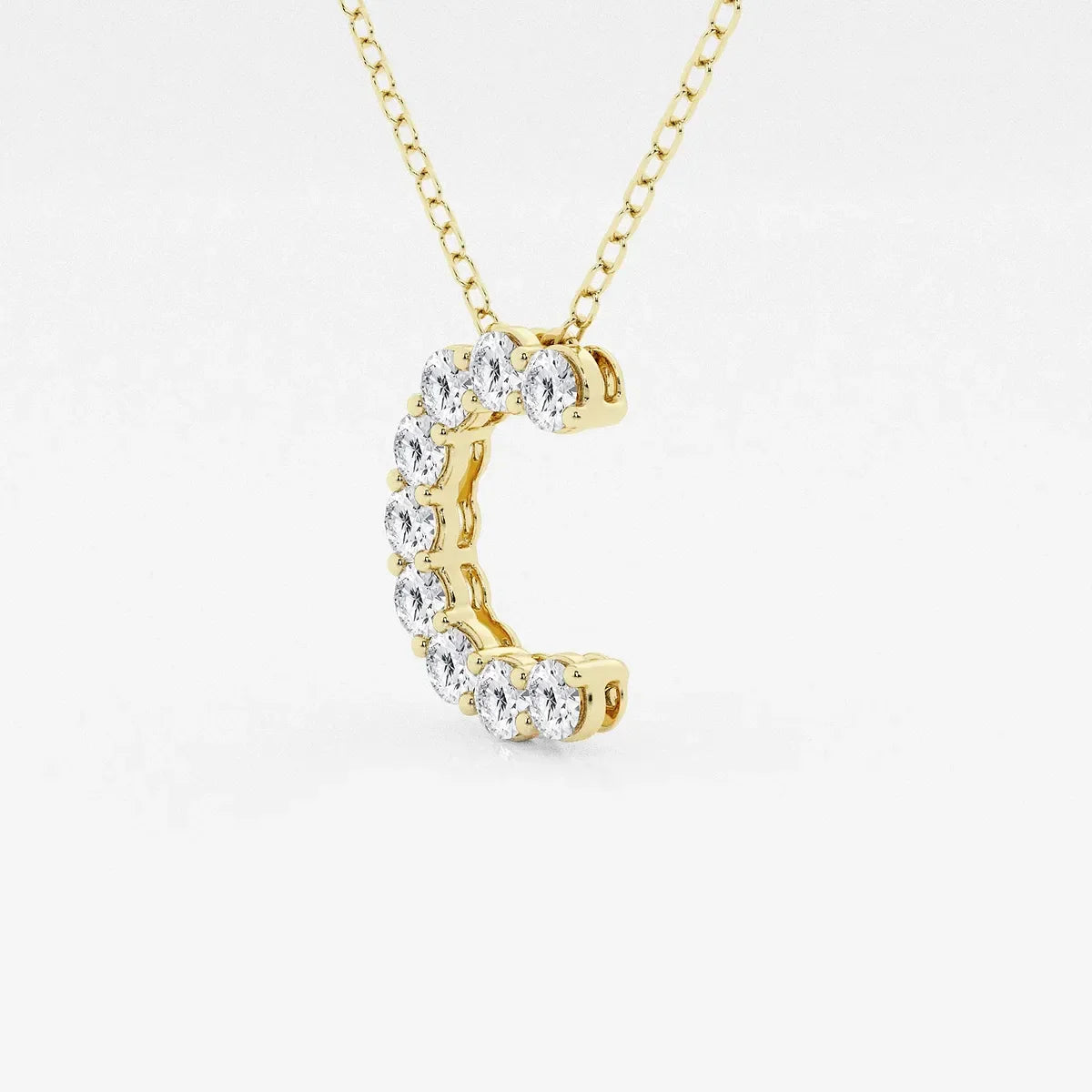 Gold necklace with a C-shaped pendant set with lab grown diamonds from Delux Jewelry