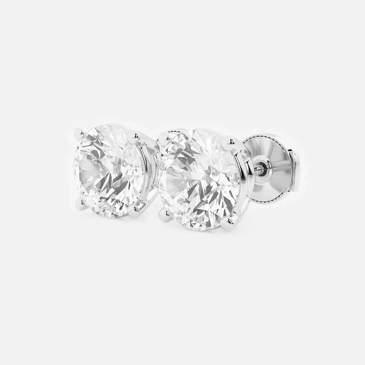 Round lab grown diamond stud earrings in white gold by Delux Jewelry on white background