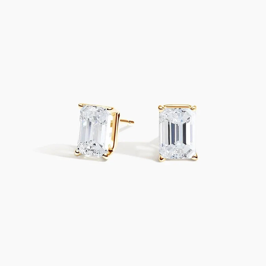Emerald cut lab diamond stud earrings in 14K yellow gold by Delux Jewelry on white background
