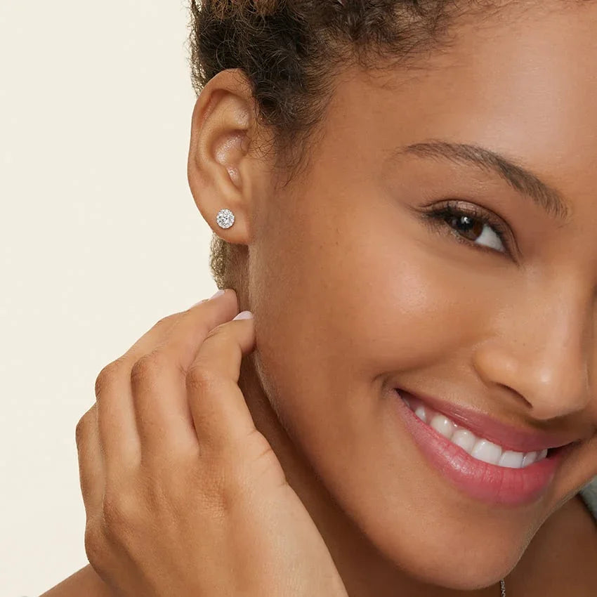 Woman wearing lab grown diamond halo stud earrings from Delux Jewelry