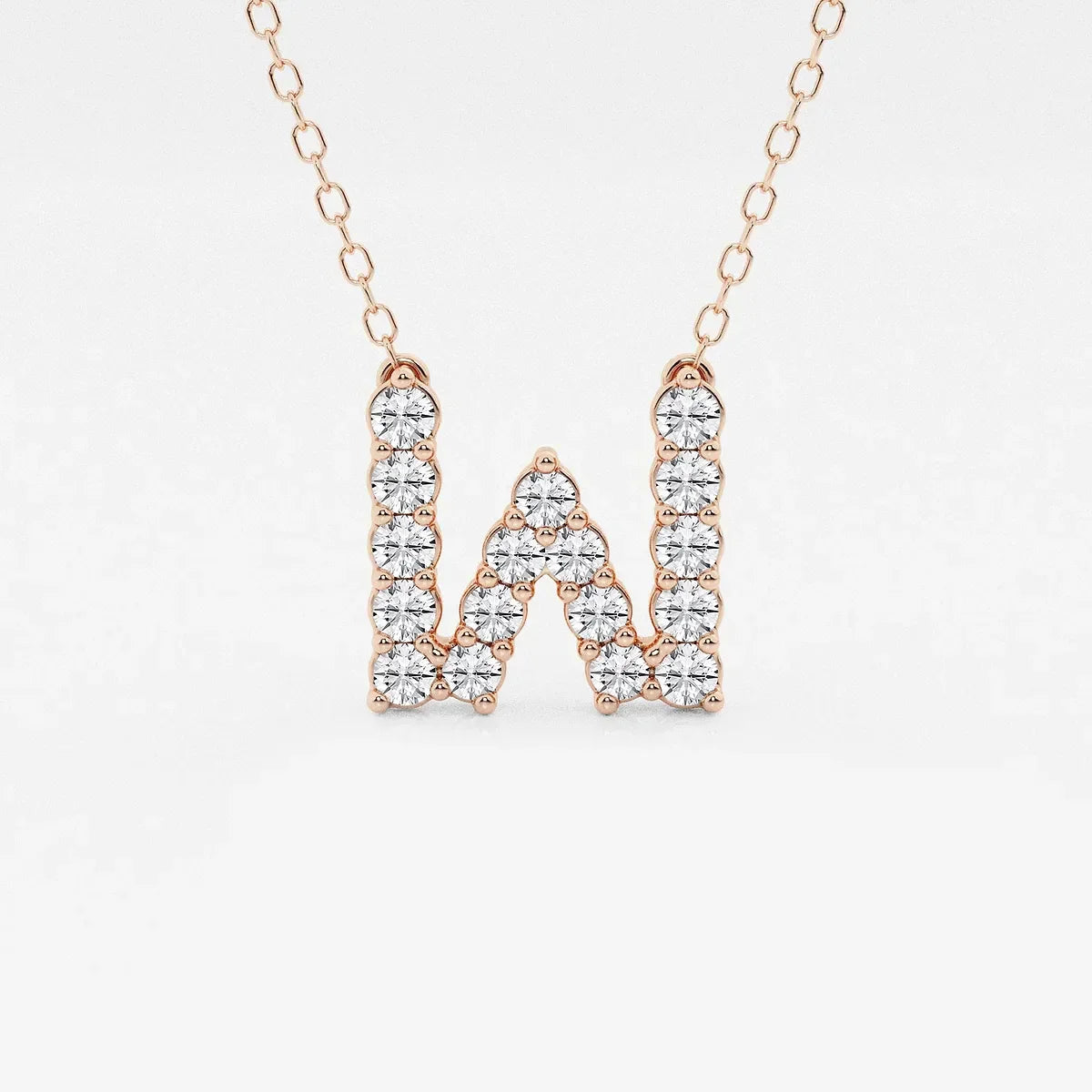 Rose gold necklace with lab grown diamond W initial pendant on a white background