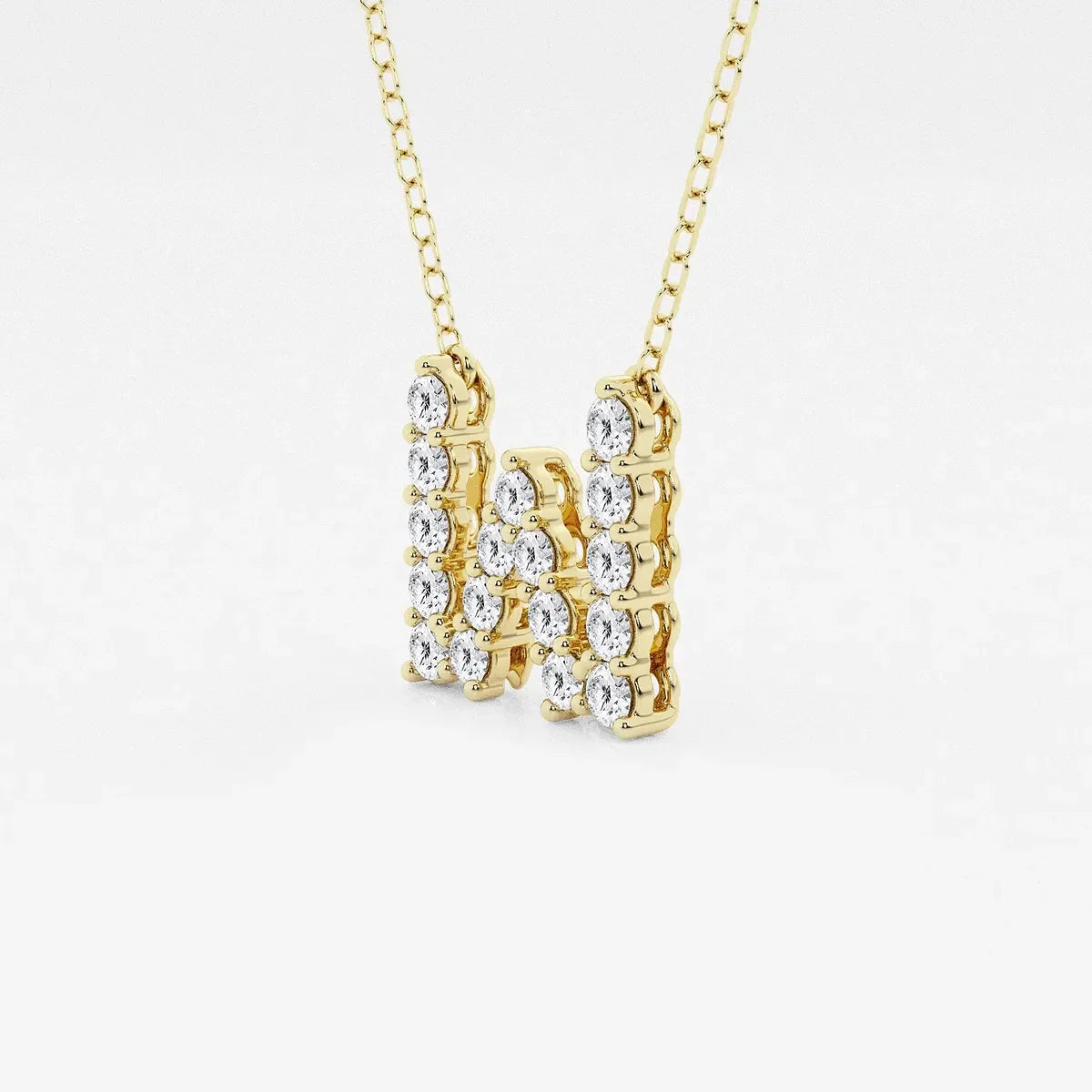 Yellow gold necklace with lab grown diamond letter W pendant on white background